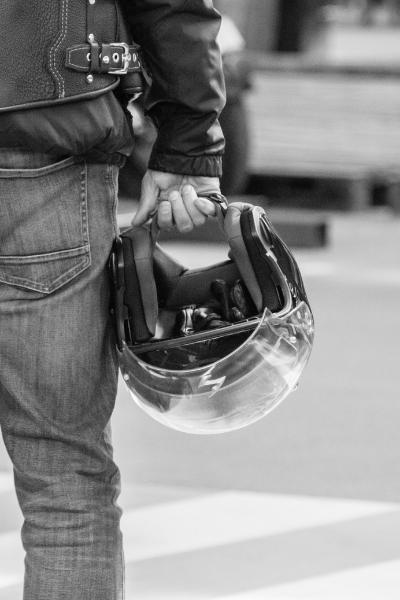 injured motorcyclist looks at accident scene