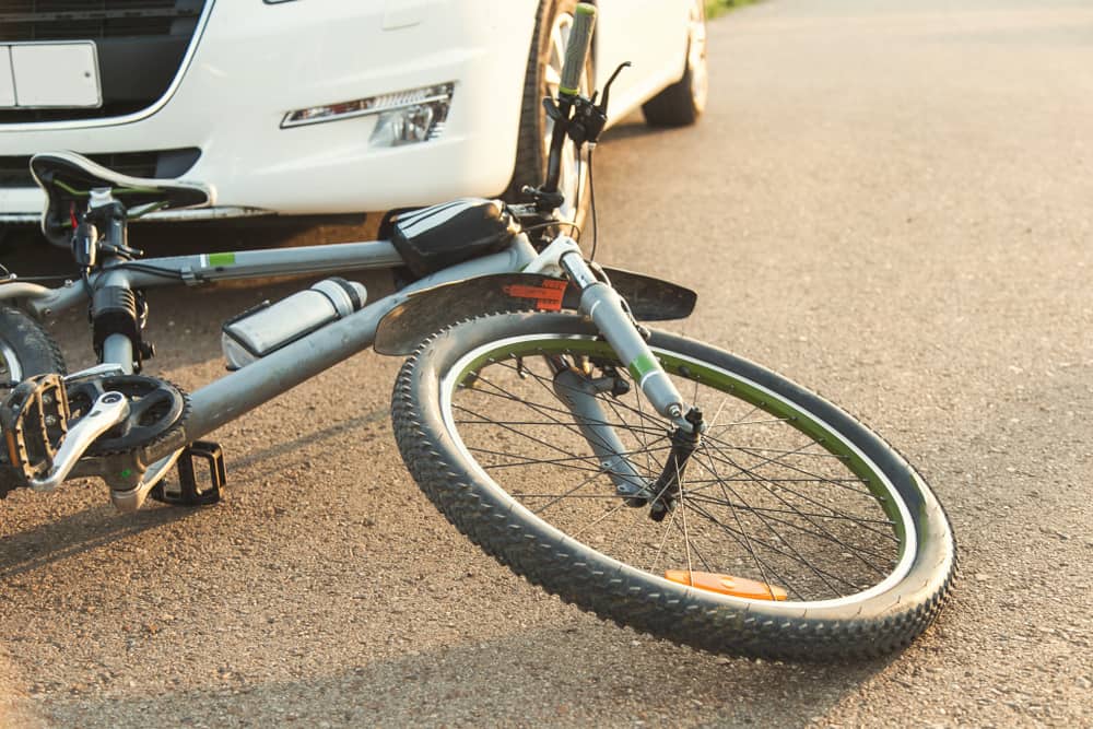 Bicycle lying on the road in front of a vehicle after a collision